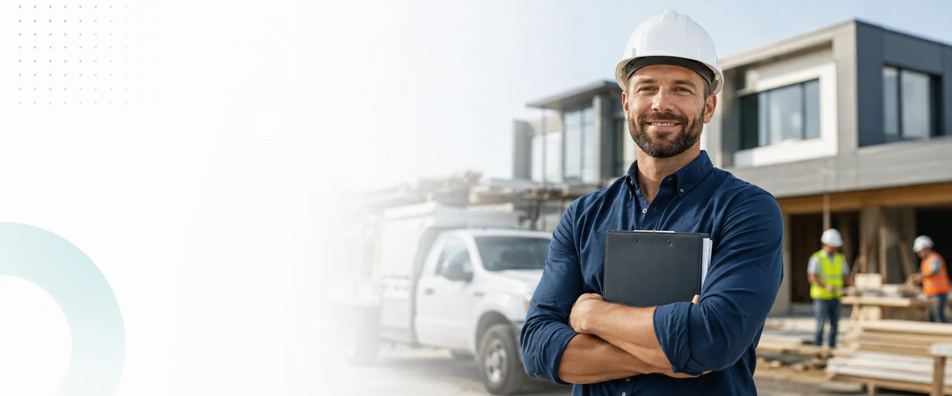 Contractor in a hard hat holding a clipboard at an active construction site
